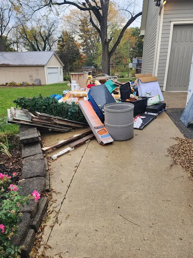 Dumpster being loaded with debris for 12 Yard Dumpster Rental in Clinton